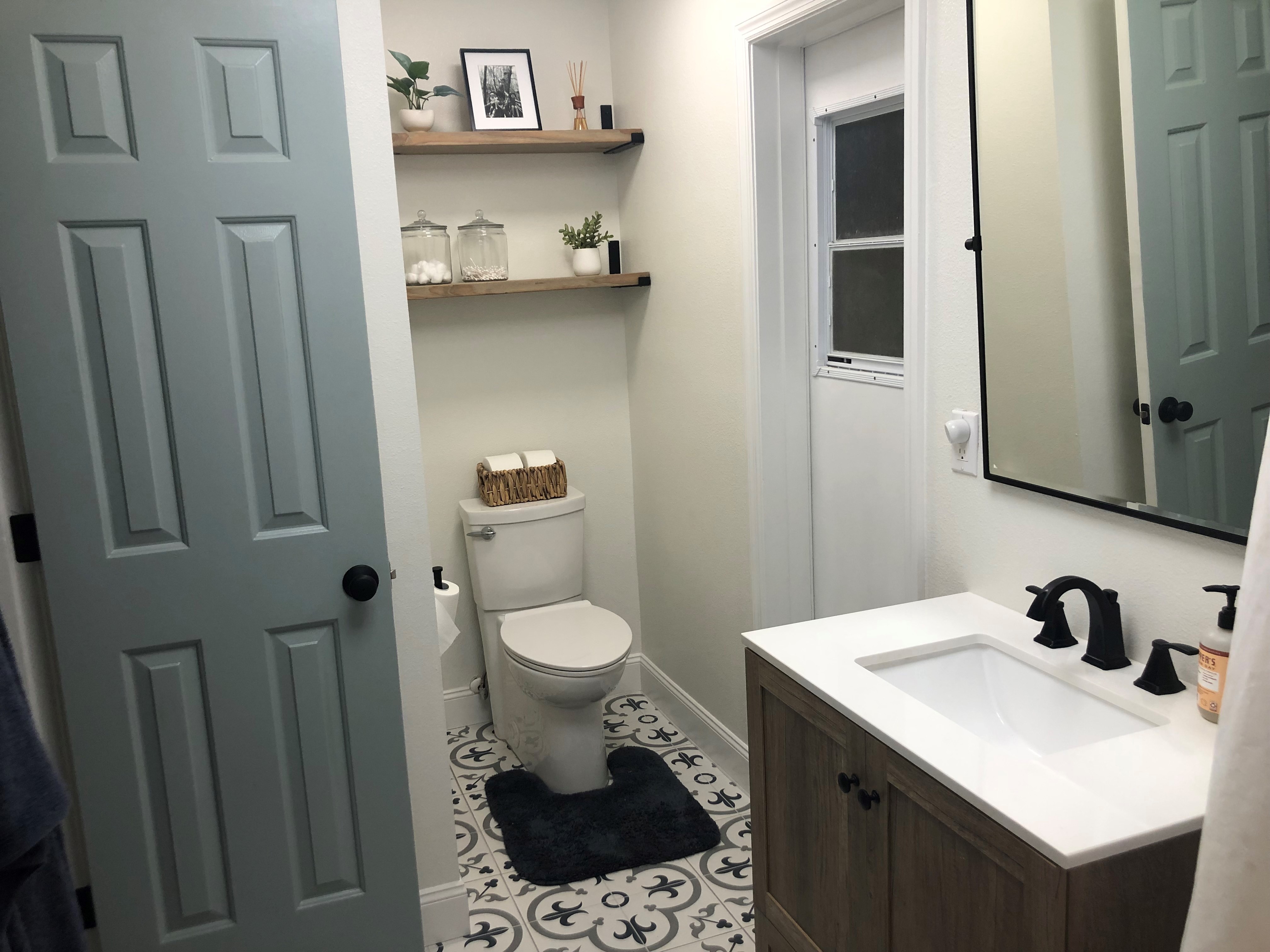 Finished Kid's Bathroom -
		The shelves were hand built and stained in a lighter grain to keep the space bright.  
		Also all my interior doors are painted this same soft blue shown to provide a cohesive flow throughout the house.